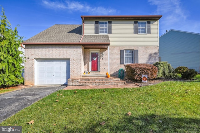 view of property with a front yard and a garage