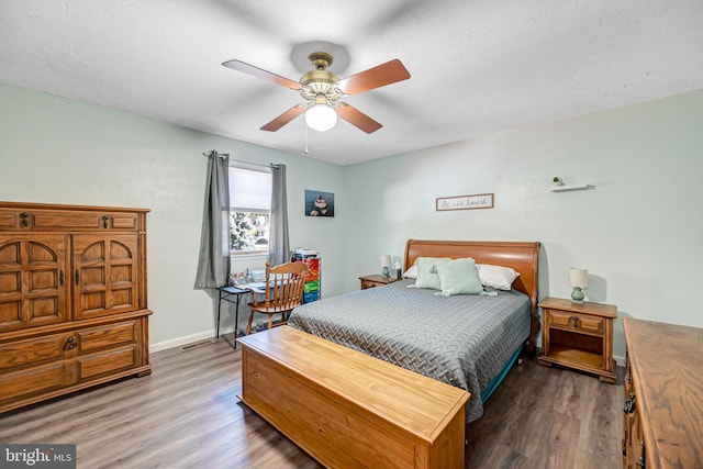 bedroom featuring dark hardwood / wood-style floors and ceiling fan