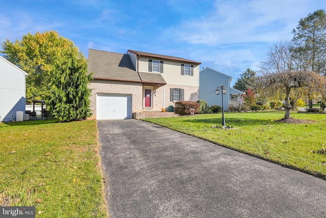 front facade with a front lawn and a garage