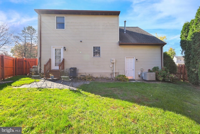 back of property featuring cooling unit, a yard, and a patio