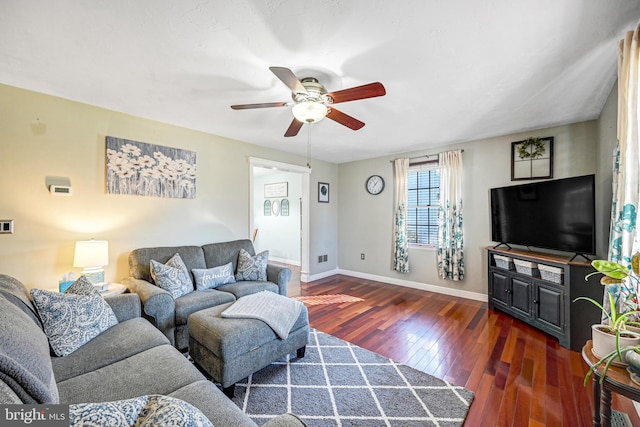 living room featuring ceiling fan and dark hardwood / wood-style flooring