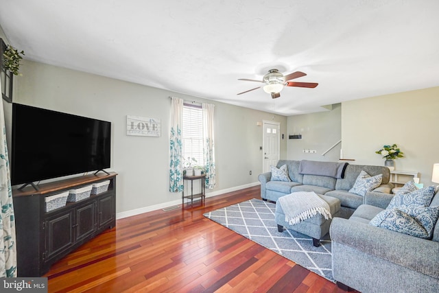 living room with dark hardwood / wood-style floors and ceiling fan