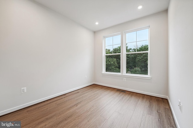 unfurnished room with light wood-type flooring