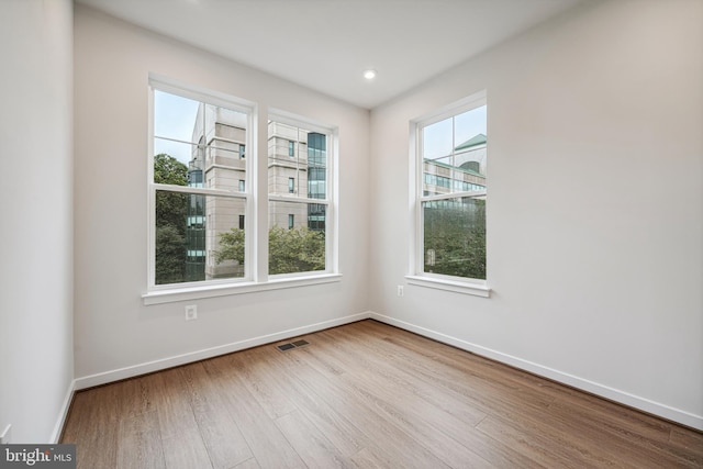 spare room featuring light hardwood / wood-style floors