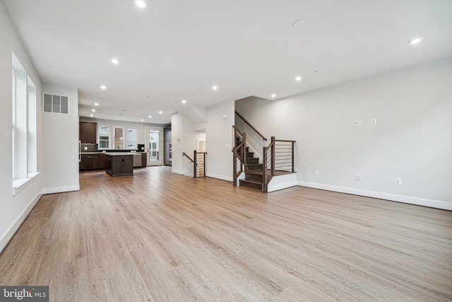 unfurnished living room with light hardwood / wood-style flooring