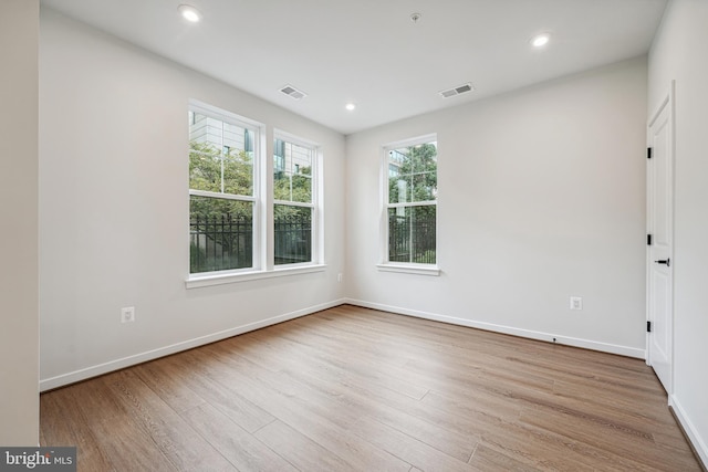 spare room featuring light wood-type flooring