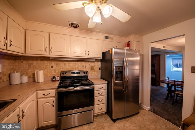 kitchen with decorative backsplash, white cabinets, stainless steel appliances, and ceiling fan