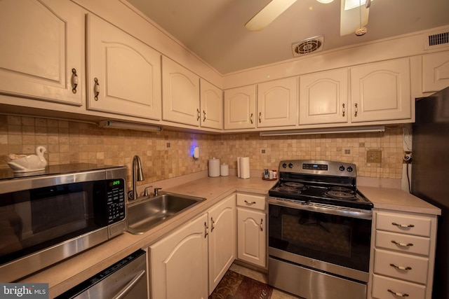 kitchen with sink, appliances with stainless steel finishes, and white cabinets