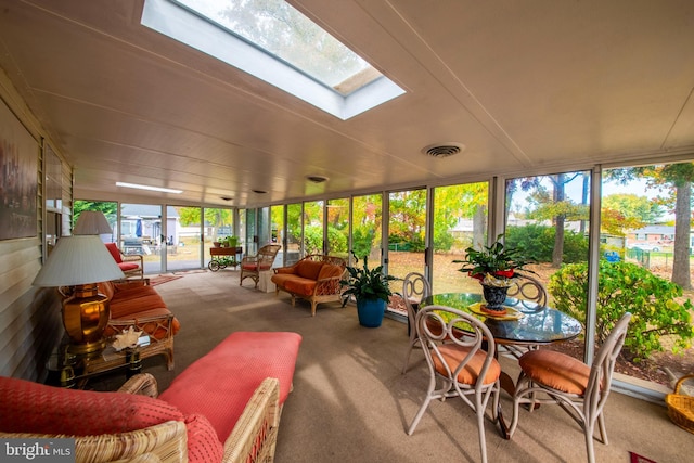 sunroom featuring a healthy amount of sunlight and a skylight