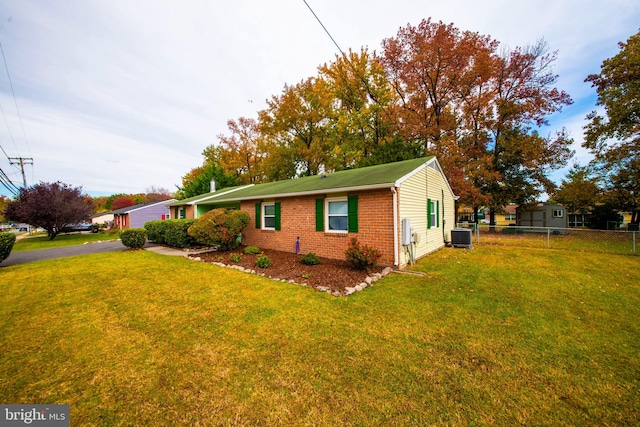 view of property exterior featuring central air condition unit and a lawn