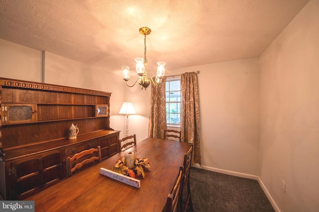 office area featuring a notable chandelier, a textured ceiling, and dark colored carpet