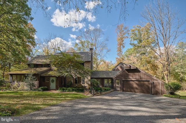 view of front of property with a garage and a front lawn