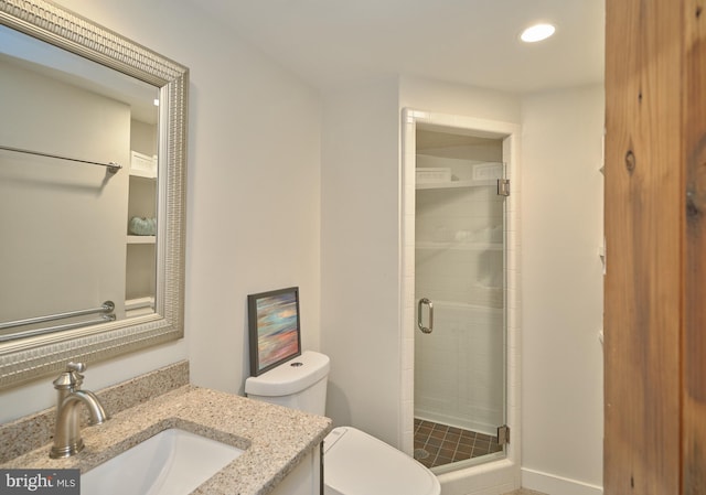 bathroom featuring vanity, toilet, and an enclosed shower