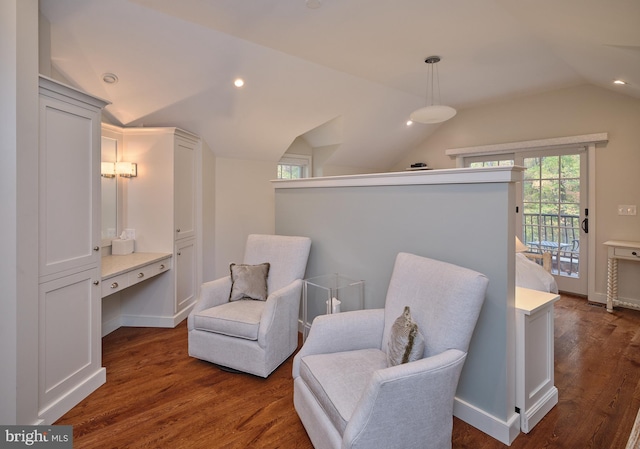 sitting room with dark wood-type flooring and vaulted ceiling