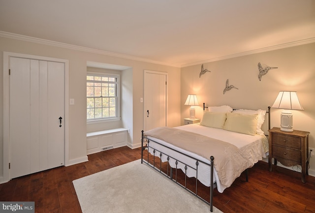 bedroom with crown molding and dark hardwood / wood-style floors