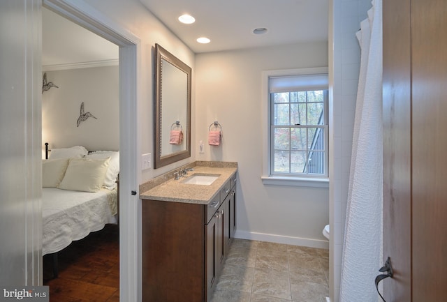 bathroom with vanity, ornamental molding, toilet, and tile patterned flooring