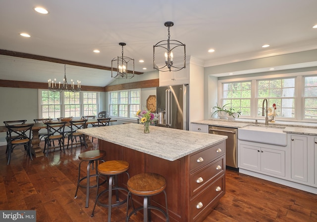 kitchen featuring sink, white cabinets, stainless steel appliances, and a healthy amount of sunlight