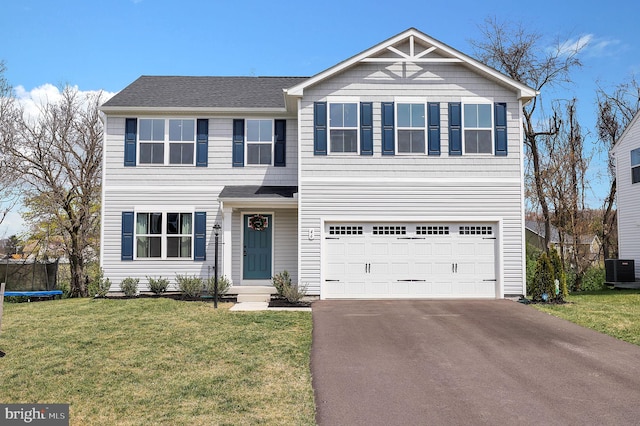 view of front of property featuring a front yard, a garage, a trampoline, and central air condition unit