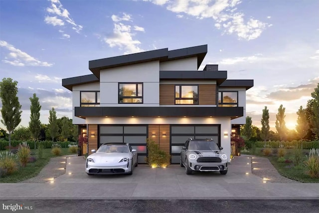 modern home featuring a garage and a balcony