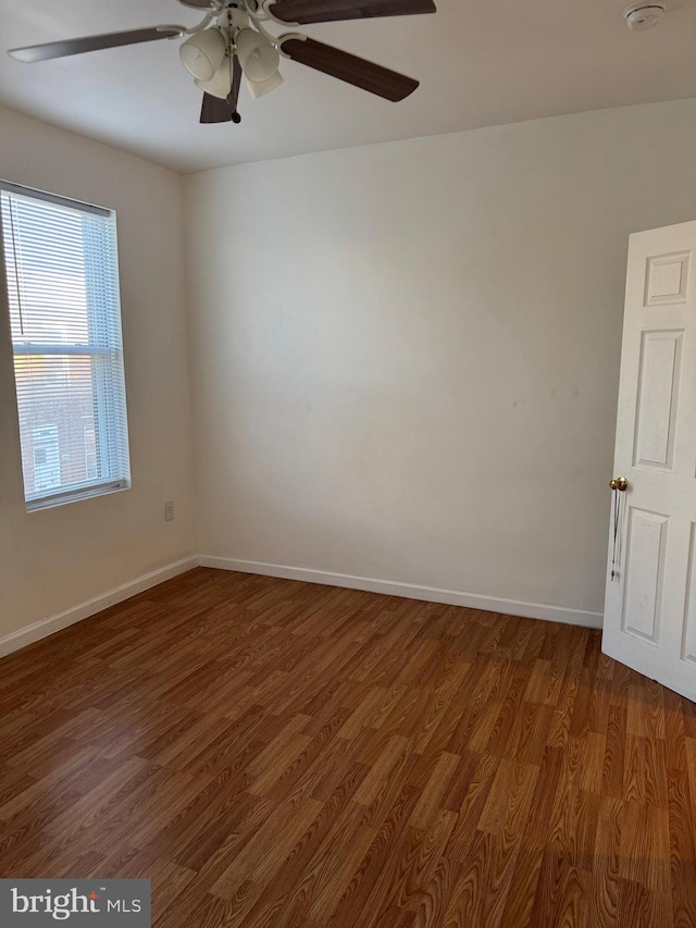 empty room featuring ceiling fan and dark hardwood / wood-style flooring