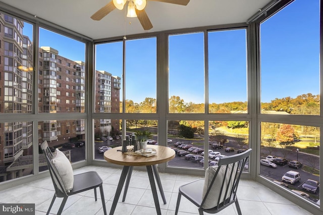 sunroom / solarium featuring ceiling fan