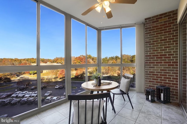 sunroom featuring ceiling fan