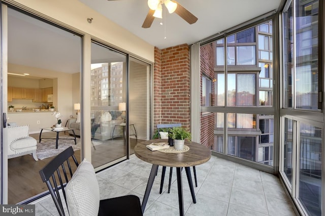 sunroom / solarium featuring ceiling fan