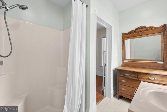 bathroom with a stall shower and vanity