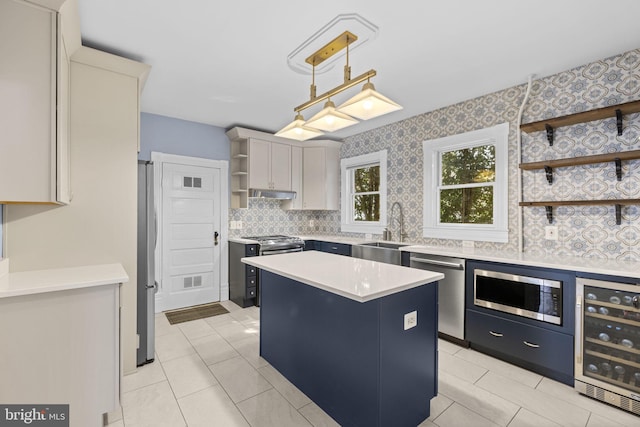 kitchen featuring pendant lighting, a center island, light countertops, open shelves, and a sink