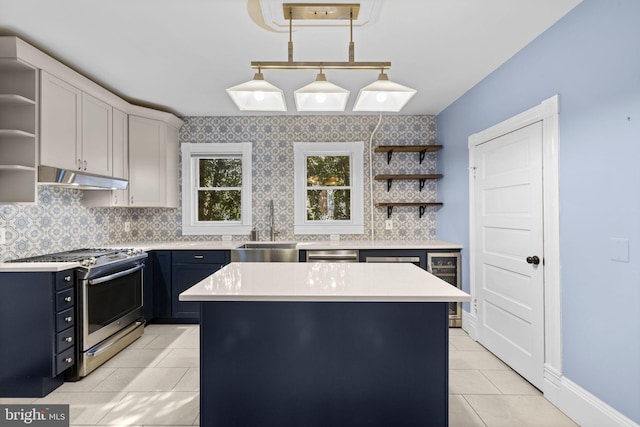 kitchen with a center island, decorative light fixtures, open shelves, stainless steel appliances, and light countertops