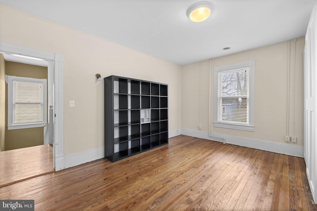 unfurnished room featuring wood finished floors and baseboards