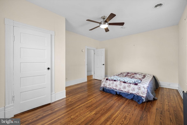 bedroom with a ceiling fan, baseboards, visible vents, and dark wood-style flooring