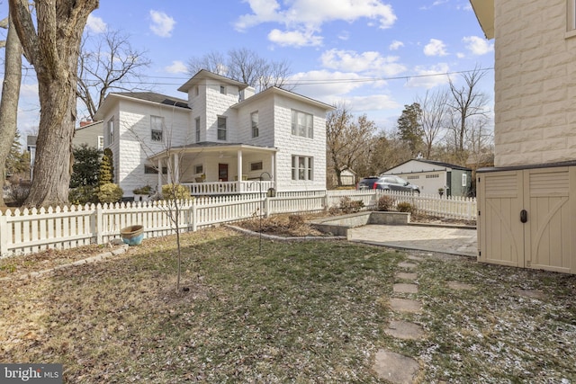 exterior space featuring fence private yard, a storage shed, and an outbuilding