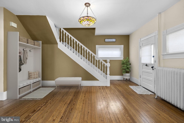 mudroom featuring radiator heating unit, wood finished floors, and baseboards