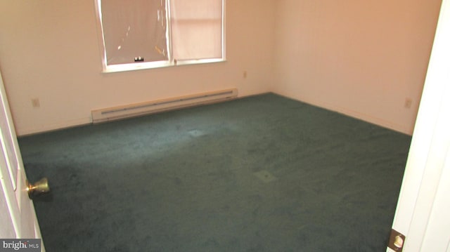 carpeted empty room with baseboard heating