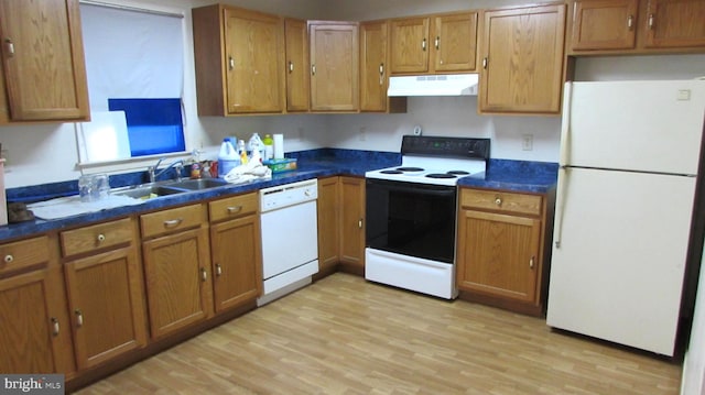 kitchen with sink, white appliances, and light wood-type flooring