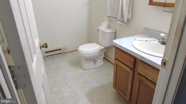 bathroom with tile patterned floors, vanity, a baseboard radiator, and toilet