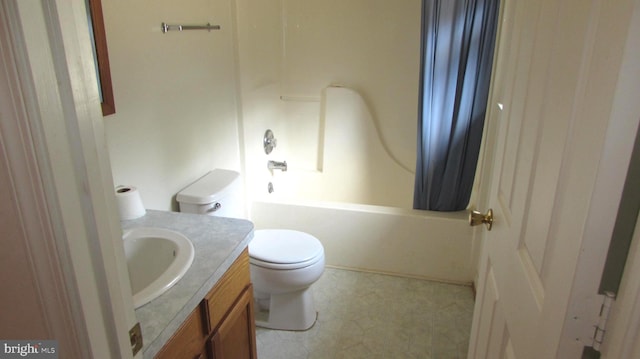 full bathroom with vanity, shower / bath combo, and toilet