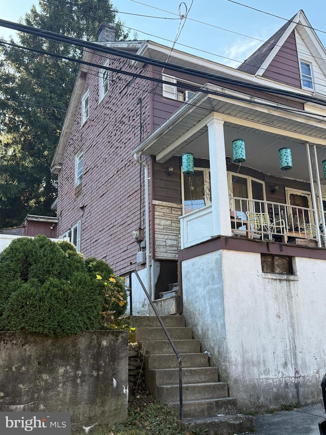 view of side of home featuring a porch