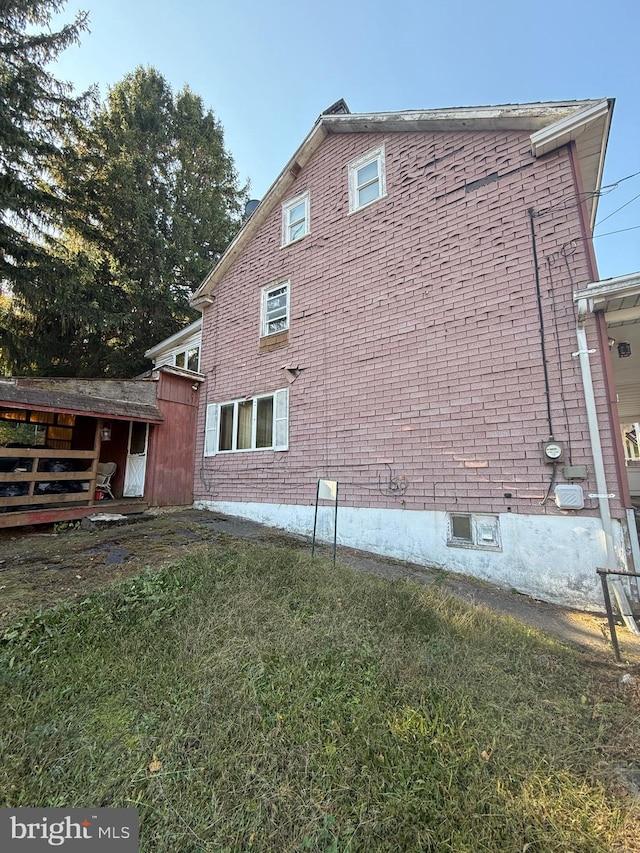 view of property exterior with a yard