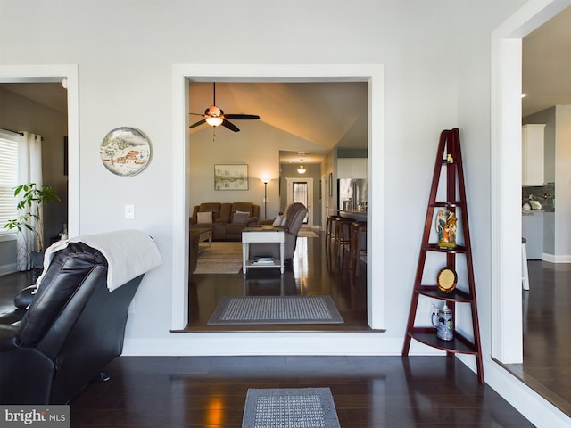 dining space featuring dark wood-type flooring, vaulted ceiling, and ceiling fan