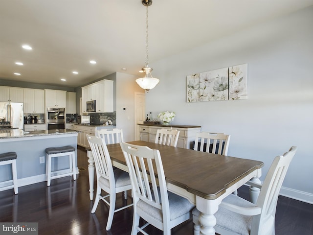 dining space with dark hardwood / wood-style floors