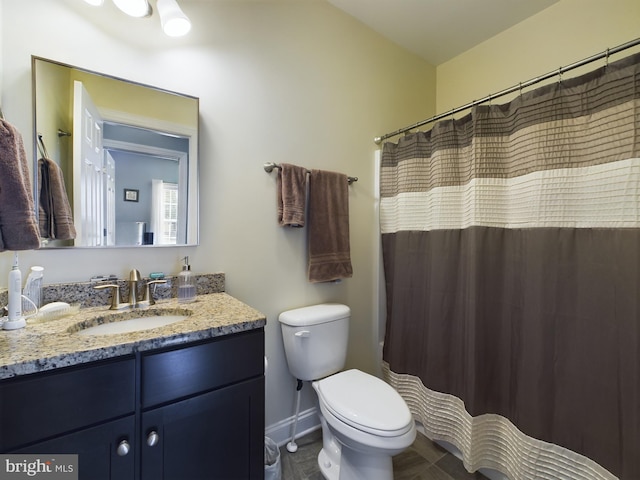 bathroom with toilet, curtained shower, and vanity