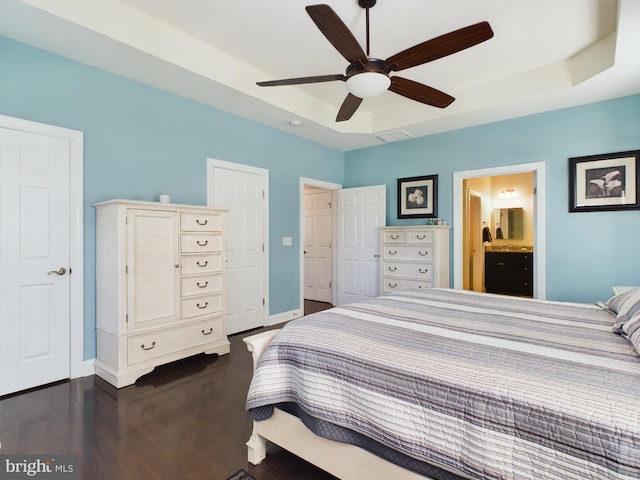 bedroom with ensuite bathroom, dark hardwood / wood-style flooring, and ceiling fan