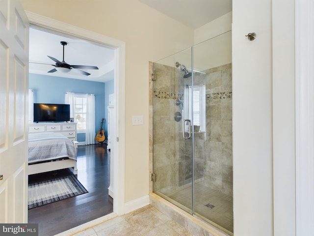 bathroom featuring ceiling fan, hardwood / wood-style flooring, and walk in shower