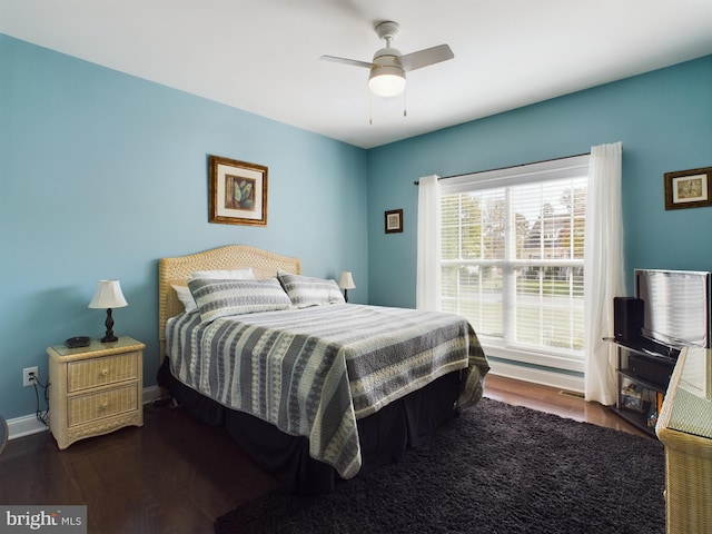 bedroom with ceiling fan and dark hardwood / wood-style flooring