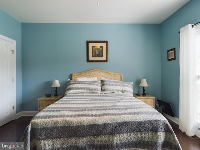 bedroom featuring dark hardwood / wood-style flooring