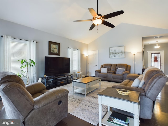 living room featuring vaulted ceiling, a wealth of natural light, dark hardwood / wood-style floors, and ceiling fan