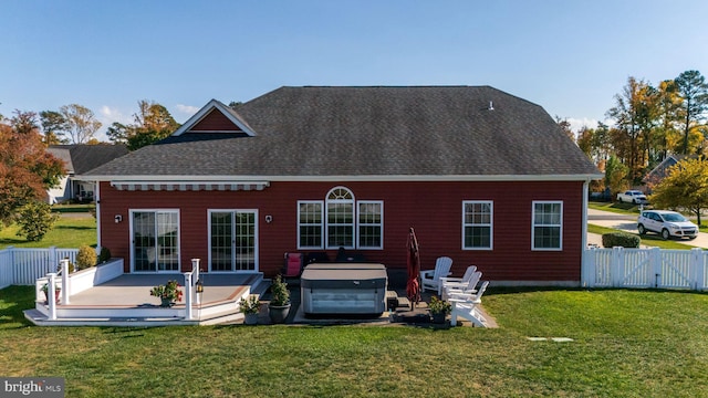 rear view of property with a patio and a lawn