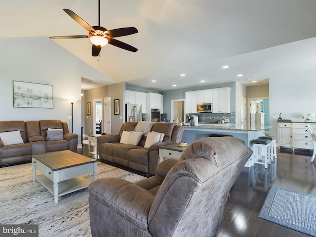 living room featuring sink, wood-type flooring, high vaulted ceiling, and ceiling fan